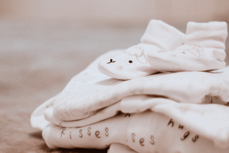 Pair of Baby's White Socks on White Textile